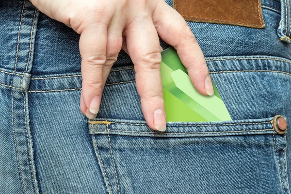 The hand pulls out a bank card from the pocket of the jeans.