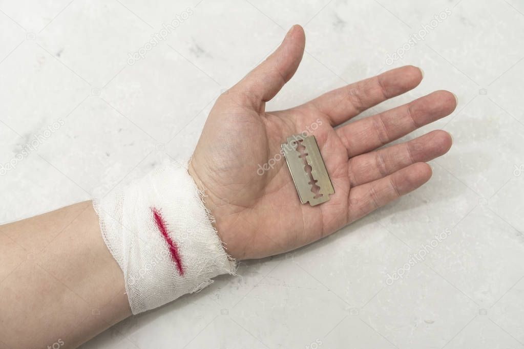 Hand with bandage on the wrist. Blood from a wound. 