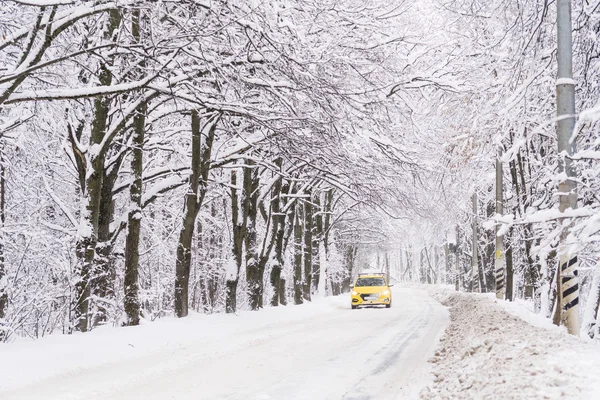 一辆黄色的出租车沿着冬日的道路行驶。很多雪。的 da — 图库照片