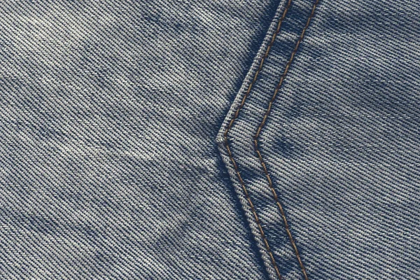 Mavi kot kumaş üzerinde bir ok şeklinde büyük bir dikiş — Stok fotoğraf