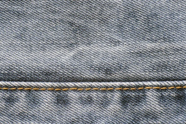 Texture of denim, seam of yellow thread, background — Stock Photo, Image