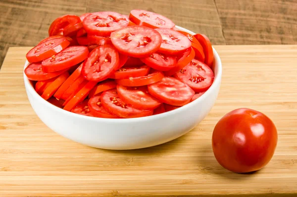 Red tomatoes sliced in a bowl — Stock Photo, Image