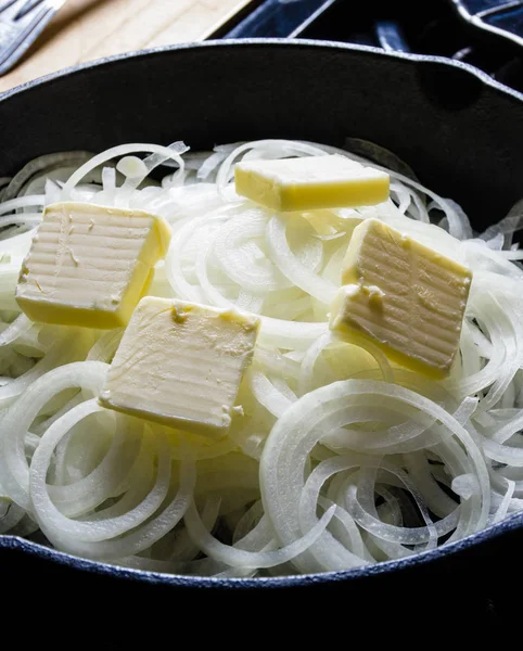 Onions cooking with butter in skillet — Stock Photo, Image