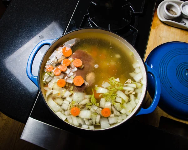 Vegetable ham soup cooking on the stove — Stock Photo, Image