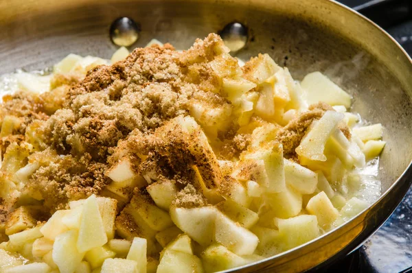 Fresh apples cut up being cooked into sauce — Stock Photo, Image