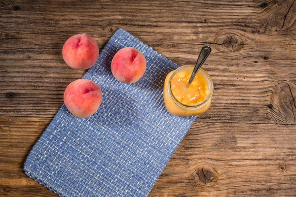 Peaches and peach jam on a table — Stock Photo, Image