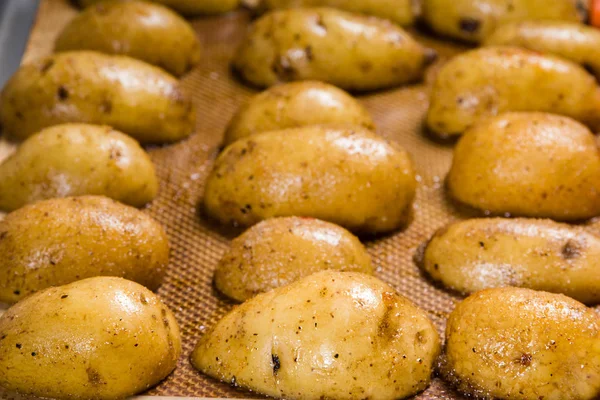 Fresh white potatoes on baking sheet — Stock Photo, Image