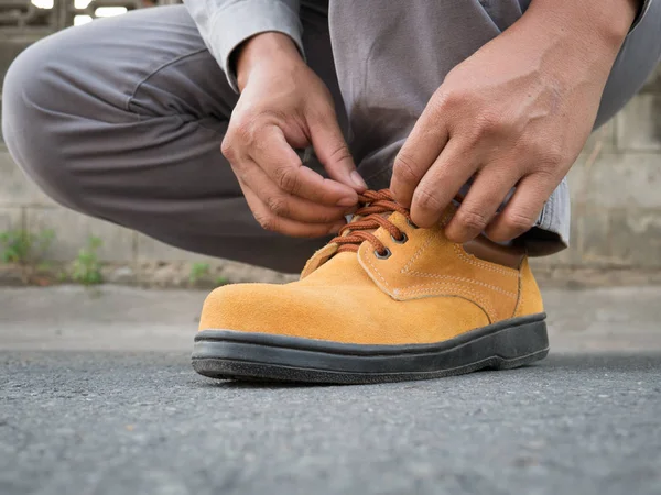 Man wears safety shoes on street