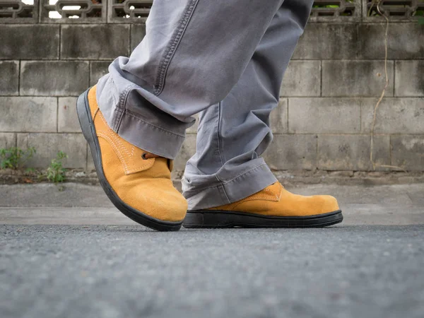 Man wearing safety shoes brown color