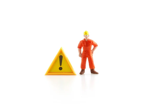 Segnale di avvertimento in costruzione con miniatura figura labo — Foto Stock
