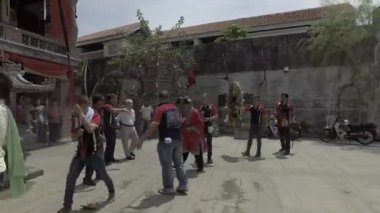 PENANG, MALAYSİYA - 6 Mart 2018: Taocu rahip tapınağın dışında dindarlarla birlikte.