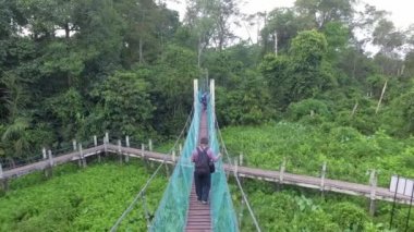 BUKIT MERTAJAM, MALAYSIA - 25 Mart 2018: Hutan Air Hitam Dalam 'daki tepe örtüsünde dikkatle yürüyen bir adam