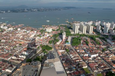 Aerial view Penang Georgertown in evening with shadow of KOMTAR building. Background is Straits of Malacca. clipart