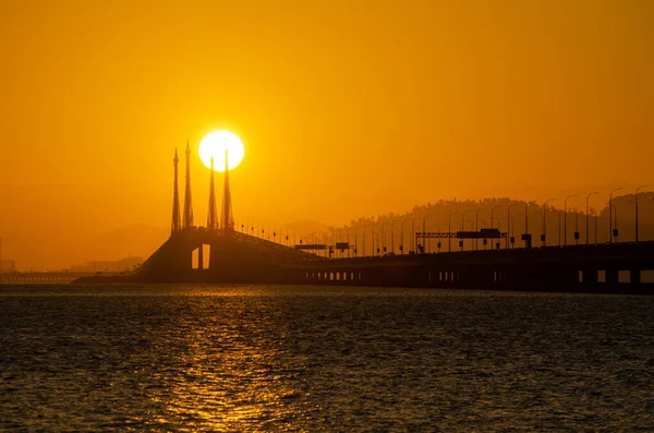 Egg yolk sunrise in morning over penang Bridge.