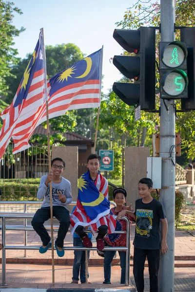 Çocuklar ulusal gün kutlamalarında Malezya bayrağı getiriyorlar. — Stok fotoğraf