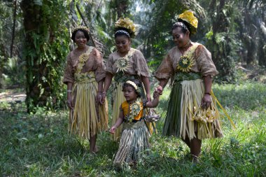 Villager Mah Meri in oil palm estate. clipart