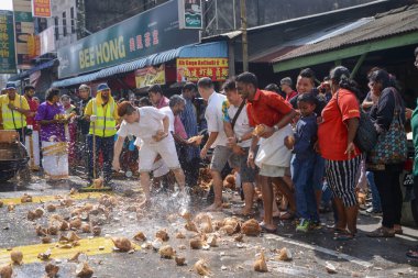 Coconuts are smashed onto the ground to fulfill sacred vows