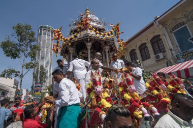Silver chariot with devotees offering in front of shop house and Komtar.