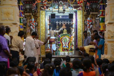 Priest hold fire in front lord Muruga during Thaipusam.