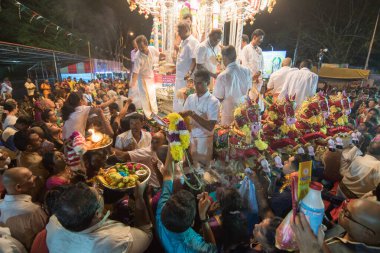 Devotees offering to deity at night during Thaipusam.