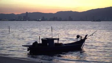 İnanılmaz renkli gökyüzü olan bir balıkçı teknesi.