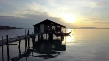 Siluet denizdeki ahşap kulübeye doğru ilerliyor..