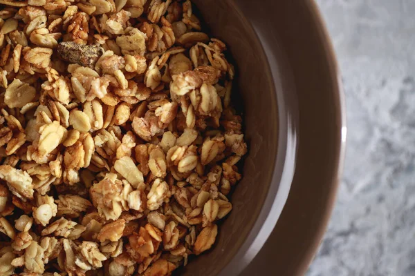 Fitness breakfast. Baked granola in a plate, close-up. Muesli, top view.