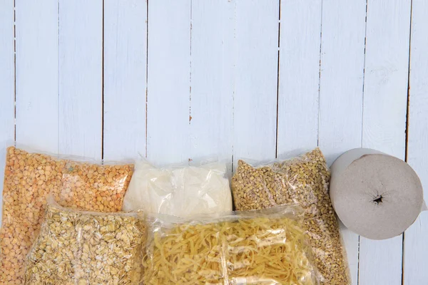 Coronavirus food donation.Cereals, toilet paper, canned food on a white background. Flat lay