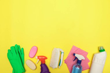 Temizlik seti, deterjan, eldivenler ve sarı arka planda bir fırça, mesaj için yer. Temizlik. Dezenfekte. Düz yatıyordu.