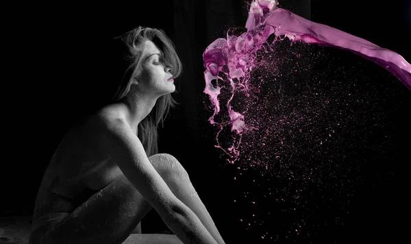 Woman with powder in the studio on a black background — Stock Photo, Image