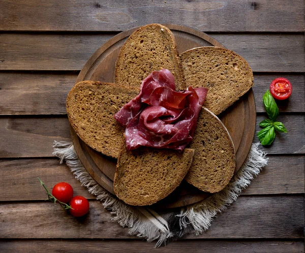 Bresaola ham on slices bread — Stok fotoğraf