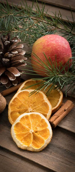 Autumnal background with dried oranges,pine and cinnamon on wood — Stock Photo, Image