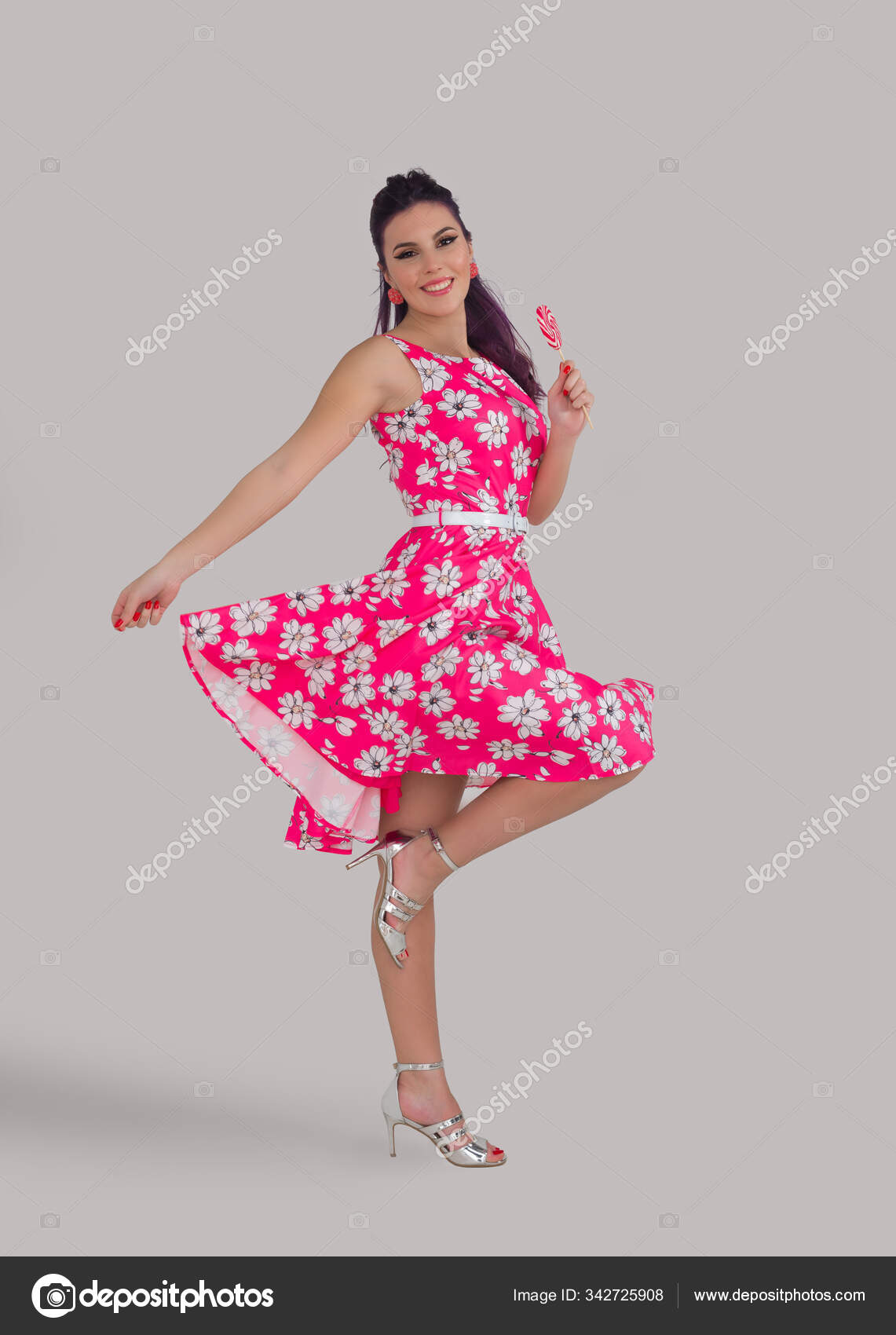 Young funny woman with vintage hairstyle, floreal dress eating Stock Photo  by ©jacklondon 342725908
