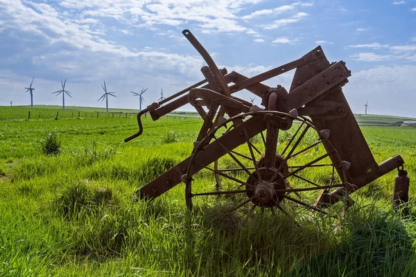 Old and new technology - wind turbines and abandoned plough