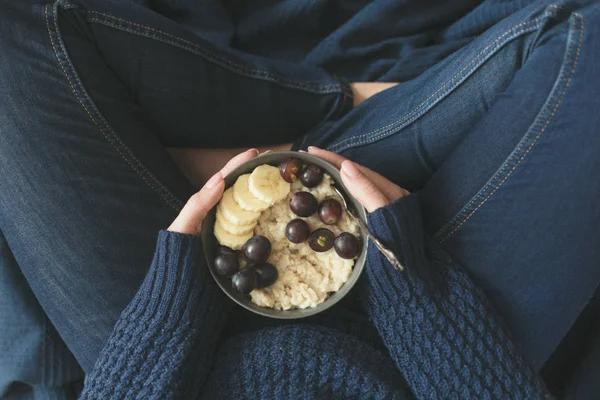 Gesundes Frühstück. graue Schale mit Haferbrei und Früchten in Frauenhänden. Ernährungskonzept — Stockfoto