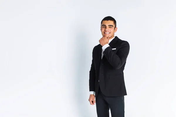 Handsome young man in a stylish suit, posing on a white background isolated — Stock Photo, Image
