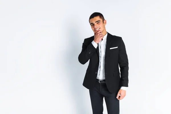 Handsome young man in a stylish suit, posing on a white background isolated — Stock Photo, Image
