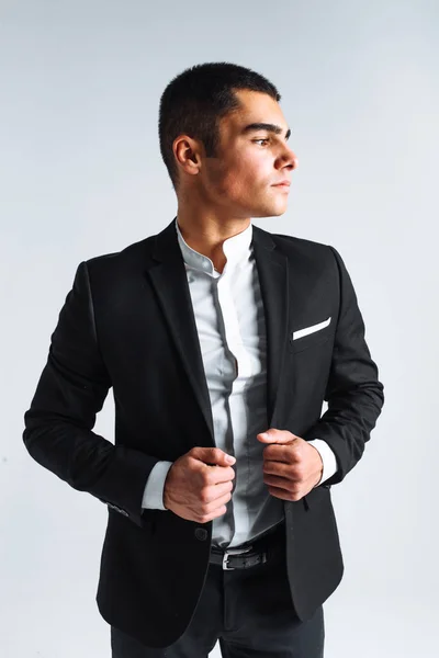 Joven guapo en un traje elegante, posando sobre un fondo blanco aislado — Foto de Stock