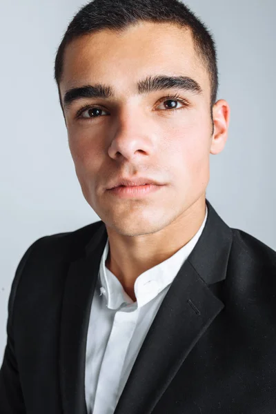 Handsome young man in a stylish suit, posing on a white background isolated — Stock Photo, Image