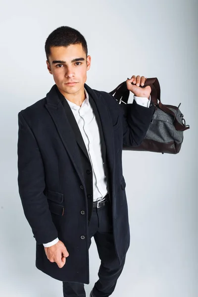 Stylish man in Studio on a white background, with a bag for travel, isolated, background, man goes on a journey — Stock Photo, Image