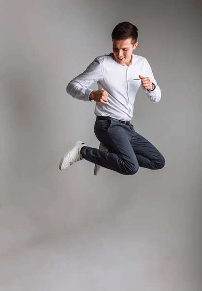 The guy jumps. The guy in the Studio. The guy in the white shirt. Handsome guy.