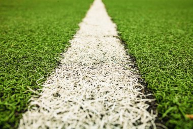 Yeşil suni çim futbol sahası. Yeşil futbol alan arka plan üzerinde beyaz çizgi.