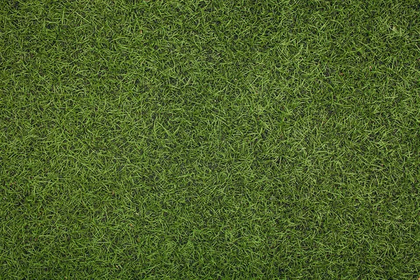 Groene kunstgras voetbalveld. De groene achtergrond. — Stockfoto