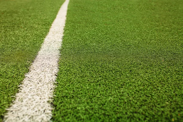 Green artificial grass soccer field. The white line on a Green football field background.