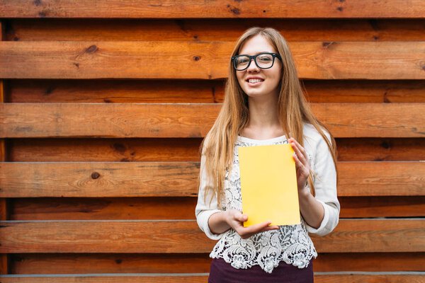 Girl reading book isolated on wooden backround. Isolated background on the book, to insert text