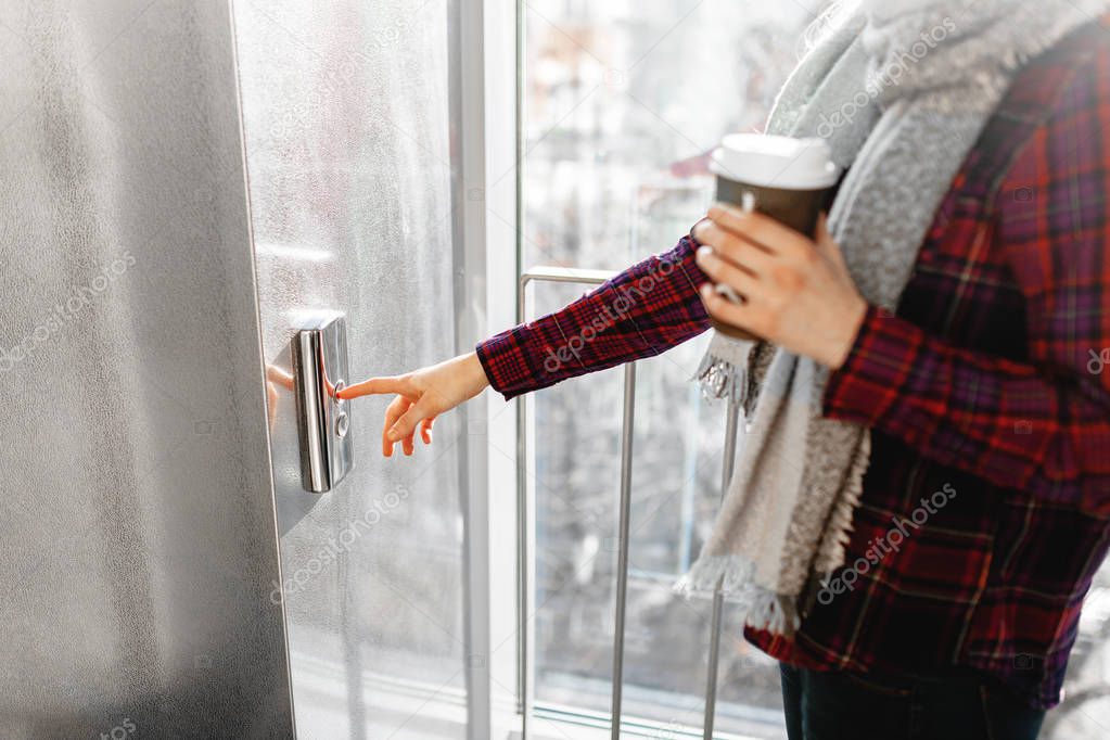 The thumb presses the Elevator button, a hand reaching for the button, the girl waiting for Elevator, push button start, isolated, the girl with the jar of coffee