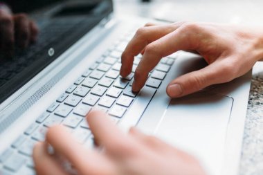 Bir dizüstü bilgisayar ile bir kafede dizüstü bilgisayar, iş arama, iş online, yazarak Closeup erkek kol,