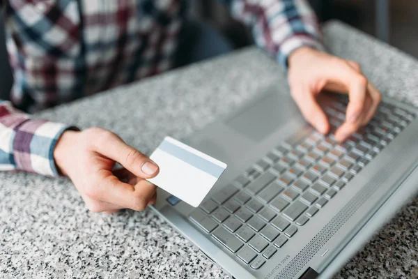 Manos de cerca, hombre hacer compras a través de Internet en un ordenador portátil, tarjeta de crédito — Foto de Stock