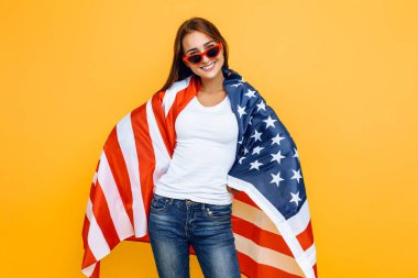 Güneş gözlüklü genç ve güzel bir kız, Amerikan bayrağıyla,