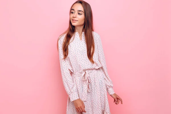 Young woman in a stylish dress. Girl posing on a pink background — 스톡 사진